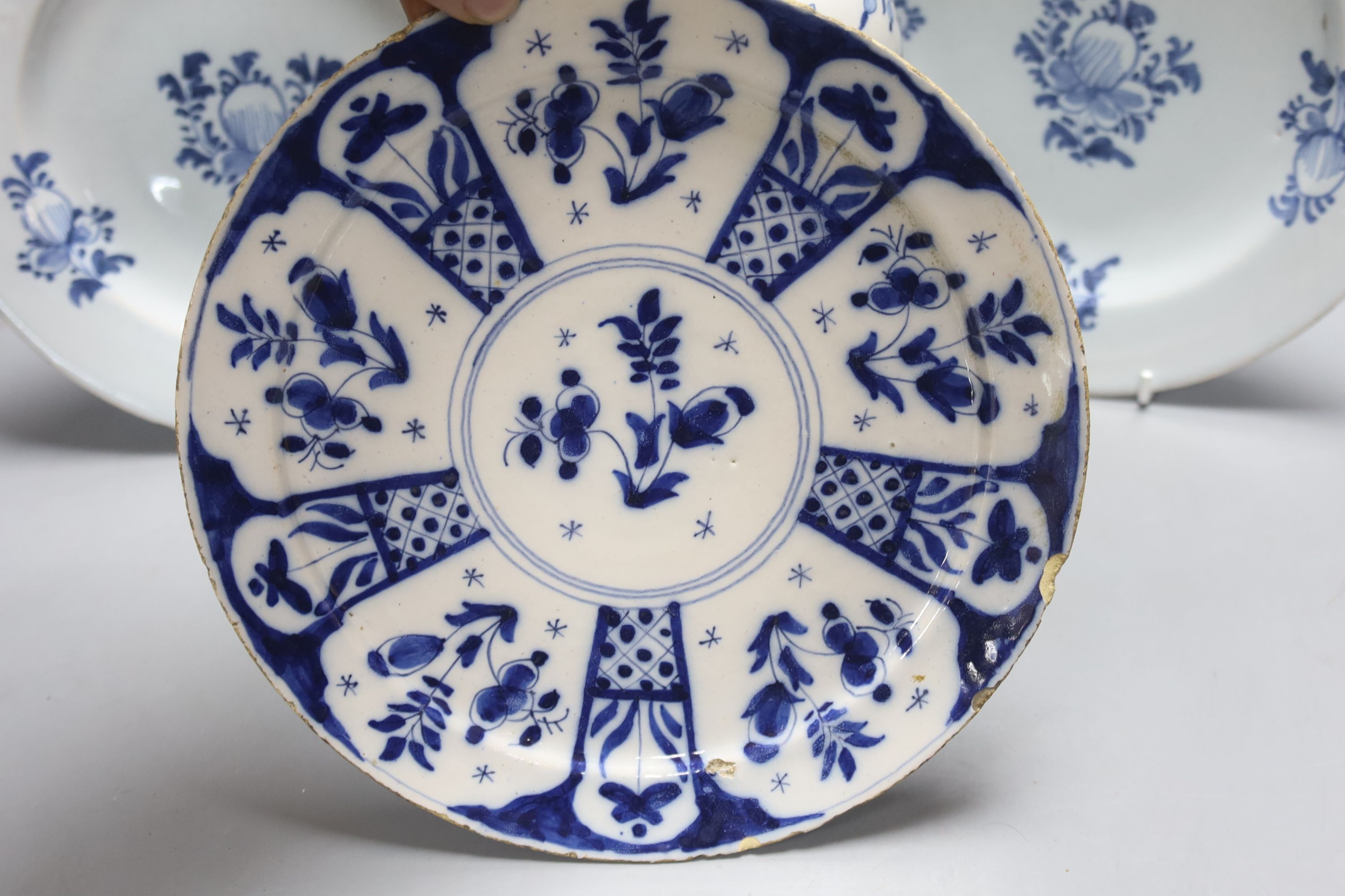 A mid-18th century Dutch Delft flower and fence-decorated blue and white baluster vase, a similar plate and a pair of English delft plates, H 20cm (vase)